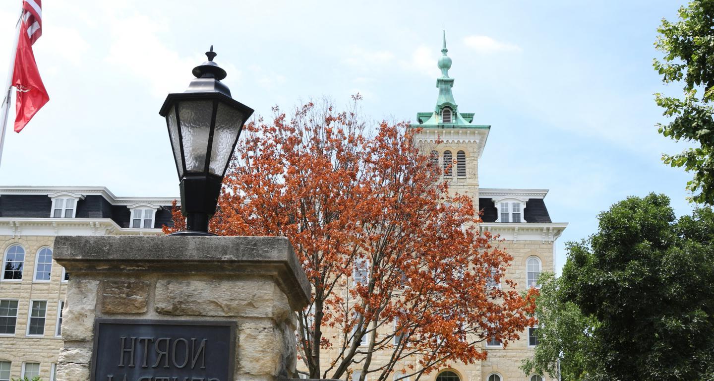 North Central College Campus, Old Main behind College Signage